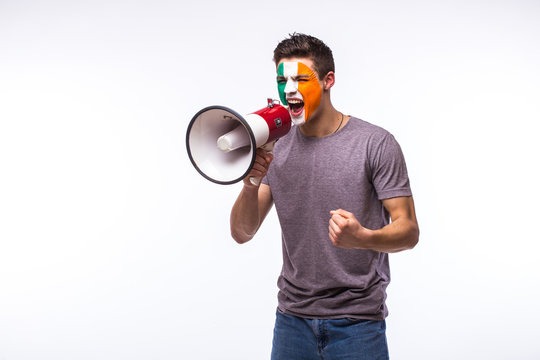 Scream On Megaphone Irish Football Fan In Game Supporting Of Republic Of Ireland National Team On White Background. European Football Fans Concept.