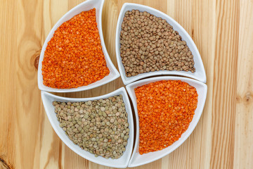 Three kinds of lentil in bowls - red lentil, green lentil and brown lentil