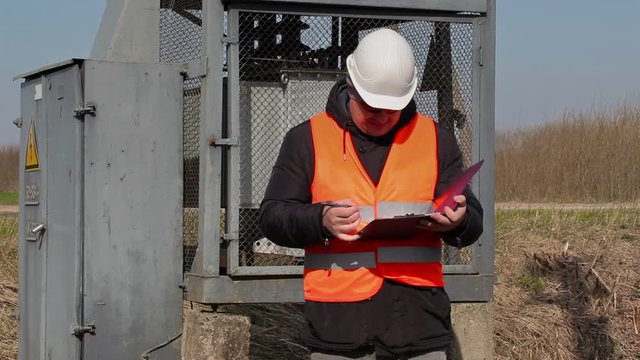Electrician inspect the transformer technical condition