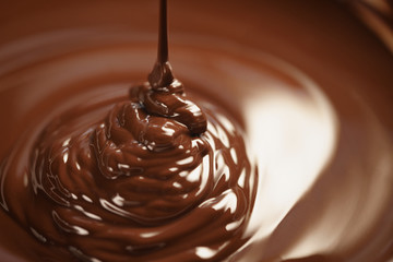 melted dark chocolate flows closeup, shallow focus