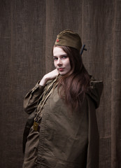 Woman in Russian military uniform with rifle. Female soldier during the second world war.