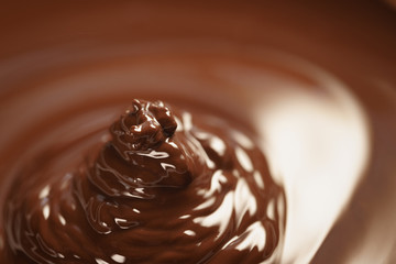 melted dark chocolate flows closeup, shallow focus