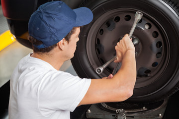 Mechanic Fixing Car Tire