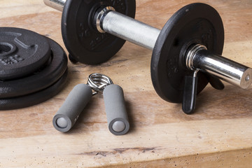 Obraz na płótnie Canvas Weights and dumbbell set for fitness on a wooden background