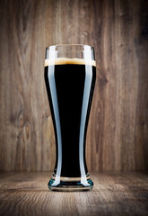 Glass of beer on wooden background