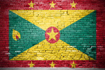 Ziegelsteinmauer mit Flagge Grenada