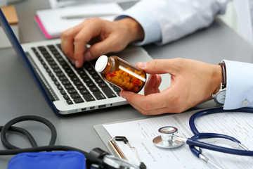 Male medicine doctor hands hold jar of pills - obrazy, fototapety, plakaty