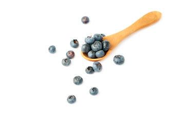 Wooden spoon filled of Bilberry or blueberry over isolated white background