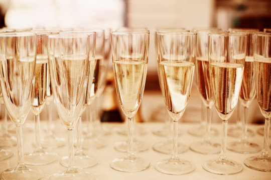 Rows of Champagne Glasses Served on Event. Image Toned with Gold Colors. Selective Focus.