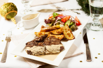 Christmas dinner. Beef steak with roasted potatoes