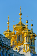 Fototapeta na wymiar Golden domes of a Christian Church in Tsarskoye Selo on the background of blue sky
