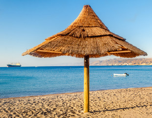 Sunshade at sandy beach of Eilat - famous resort city in Israel
