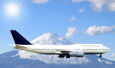 Fototapeta na wymiar Airplane flying in the sky with beautiful sunlight and Fuji mountain background.