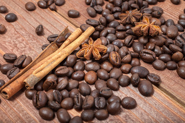 Coffee beans and spices on a wooden table