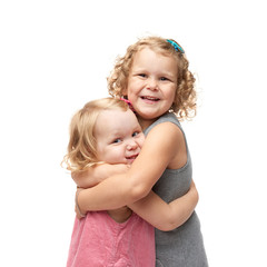 Couple of young little girls standing over isolated white background