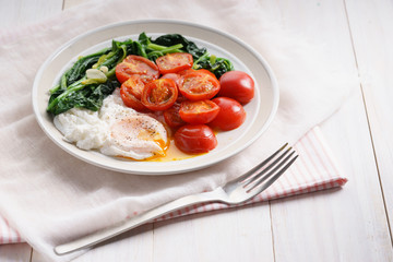 tomato and spinach salad with egg.