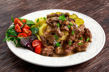 Beef Stroganoff with mashed potatoes and some vegetables.