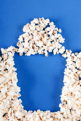 full box of popcorn on blue background