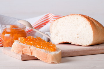 white bread, spread with apricot jam