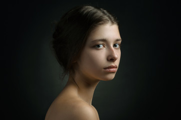 Dramatic portrait of a girl theme: portrait of a beautiful girl on a background in the studio - 109367245