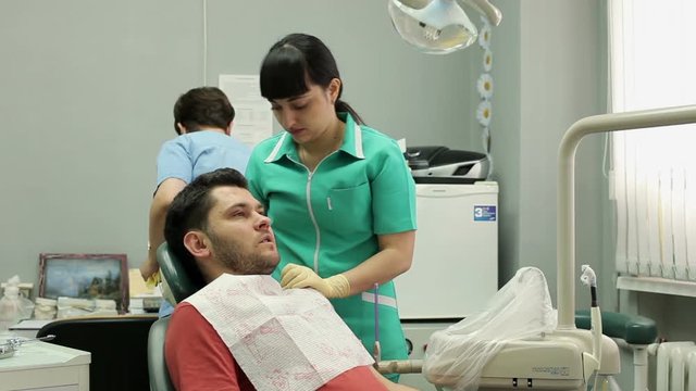 Treatment of caries. Man visits the dentist.