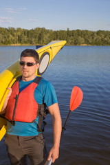Men travel by canoe on the river in the summer a sunny day.