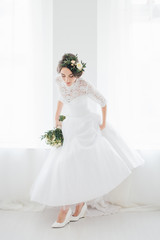 Beautiful happy young bride waiting for groom.