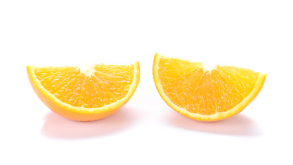 Orange cut pieces on white background.