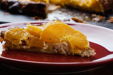 Slice of tart with cheese and sliced orange