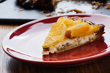 Slice of tart with cheese and sliced orange