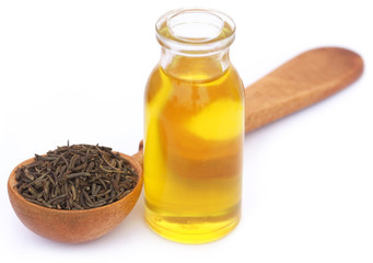 Caraway seeds with essential oil in glass bottle