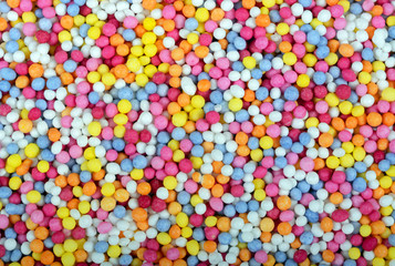 Fototapeta na wymiar Hundred and thousands sugar balls food background.
