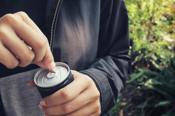 Cola can and hand