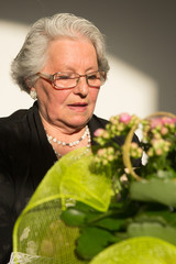 elegant elderly woman with glasses