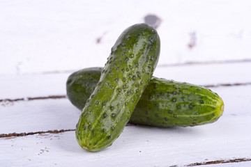 green cucumber on old boards