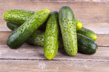 green cucumber on old boards