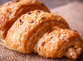 Fresh baked croissant with seeds and on burlap