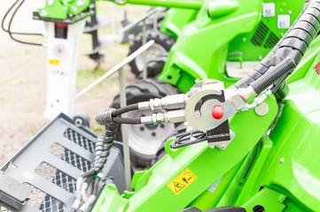 Green machines lined up outside the park