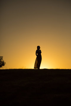 woman against the setting sun