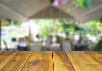 blurred image wood table and abstract coffee shop background.