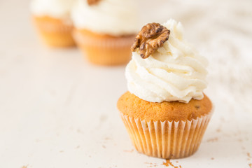 Carrot cupcakes on white wood
