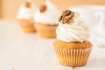 Carrot cupcakes on white wood