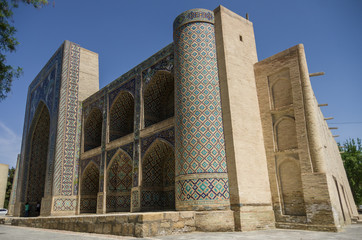 The facade of Nadir Divan-Beghi madrasah is decorated with multicolored majolica with a predominance of blue tones, Bukhara, Uzbekistan.