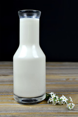 Milk in a bottle on wooden background