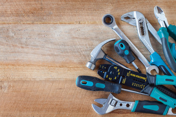 Many tools on old wooden panel