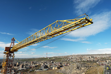 Fototapeta na wymiar Crane tower against a blue sky