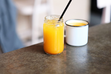 Homemade lemonade in jar and cup of tea