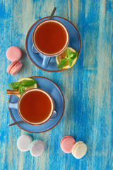 Colorful macaron with two cups of tea 