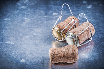 Fototapeta na wymiar Alcohol cork taps with twisted wires on metallic background