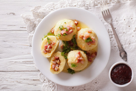 Potato dumplings stuffed with ham, bacon and onion close-up. horizontal top view
